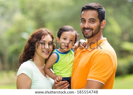 young happy indian family with the kid outdoors