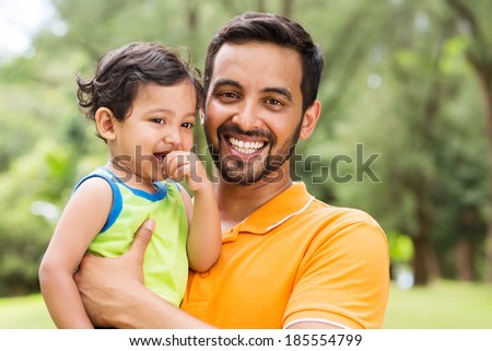 close up portrait of young indian father and baby boy outdoors