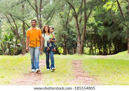 happy young indian family going for a walk in forest