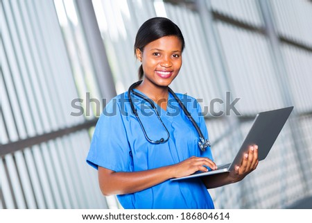 portrait of pretty afro american doctor using laptop computer