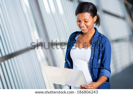 smart female african college student using laptop computer
