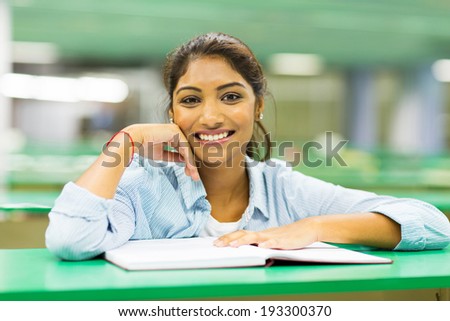 pretty indian college student in library