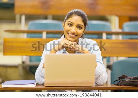 portrait of cute indian college student in lecture room