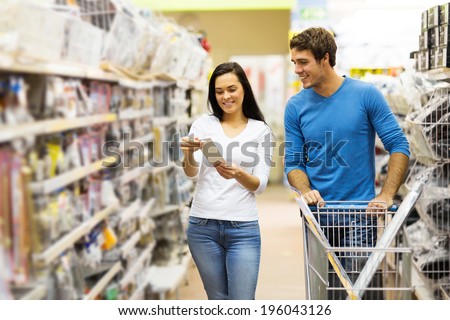 young couple shopping for DIY tools at hardware store