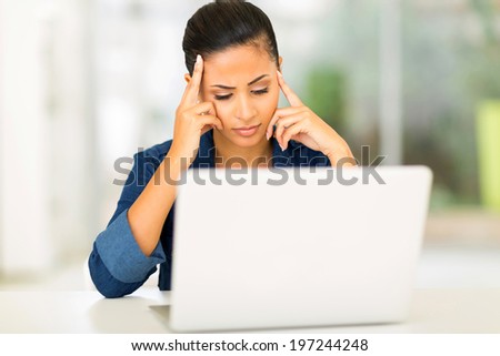 unhappy young woman looking at computer screen