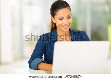 happy college student using laptop computer