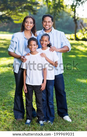 young indian family standing together outdoors