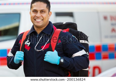 happy emergency medical service staff carrying equipment