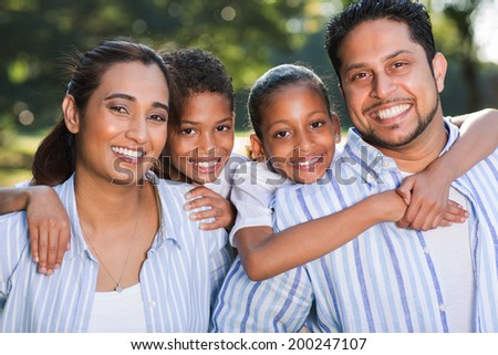 portrait of indian family having fun together outdoors