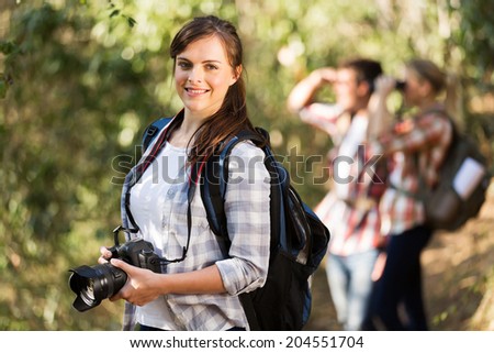 beautiful young woman climbing mountain with friends