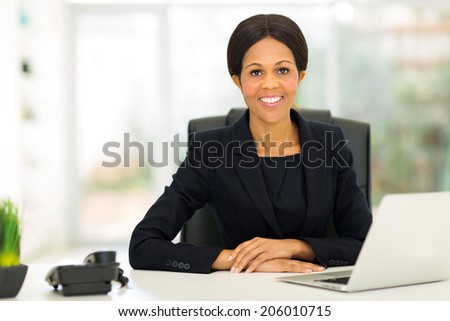 gorgeous african middle aged businesswoman in office looking at the camera