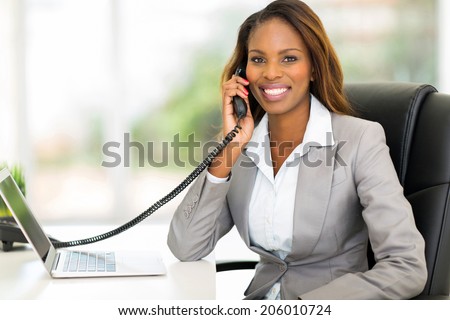 attractive african american office worker talking on the phone