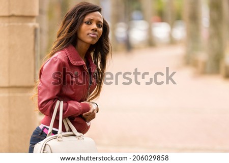 attractive african woman waiting for a taxi