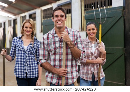 group of young stable workers with tools
