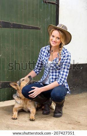 happy country girl and her dog inside farm house
