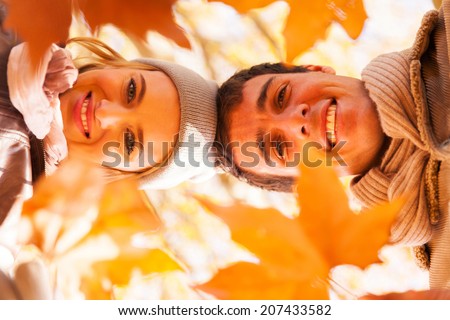 underneath view of happy young couple in autumn park