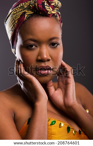 gorgeous african female model posing over black background