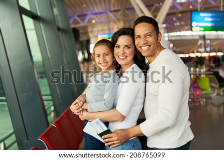 cheerful young family at airport waiting for their flight