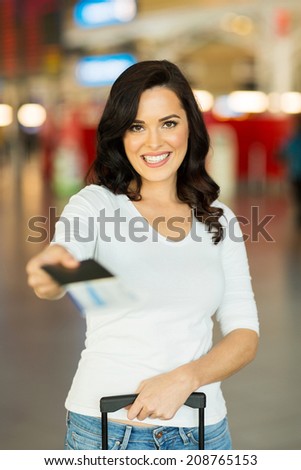pretty woman handing over air ticket at airline check in counter