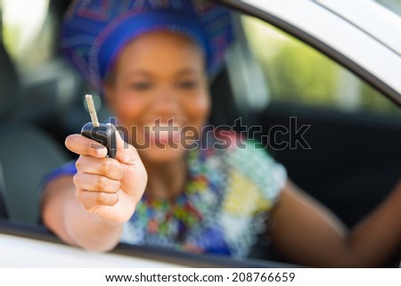 african zulu woman showing car key inside new vehicle