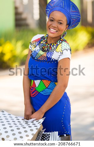 happy african zulu woman with shopping bags in mall