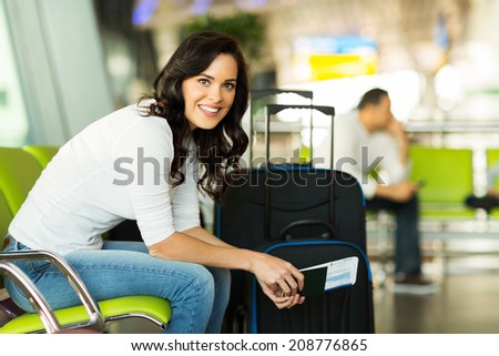 happy woman waiting for flight at airport happy woman waiting for flight at airport