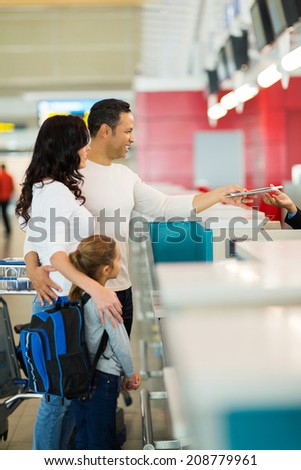 family checking in at airline counter in airport
