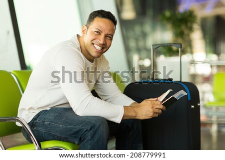happy man holding smart phone at airport