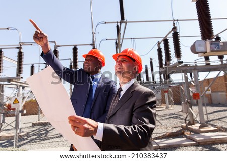 two inspectors working together in electrical substation