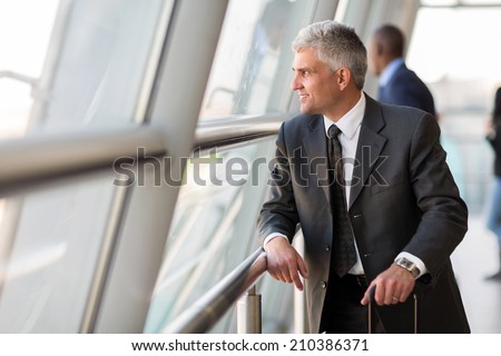 thoughtful senior business traveler at airport