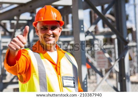 middle aged electrician giving thumb up in substation