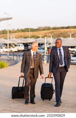 smart businessmen walking in airport parking lot