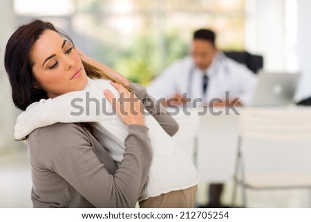 caring mother comforting her ill daughter in doctor\'s office