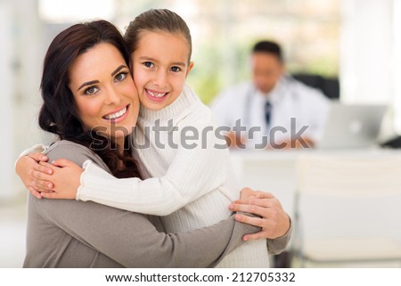 beautiful mother and daughter hugging in doctor\'s office