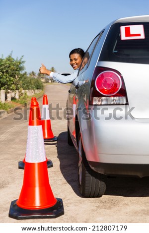 cheerful african student driver giving thumb up