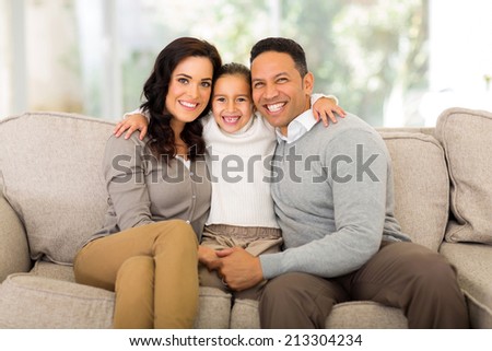 happy family sitting on the couch at home
