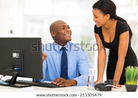 professional african manager with businesswoman working on computer