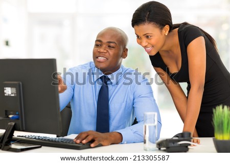 handsome african businessman and secretary working in the office
