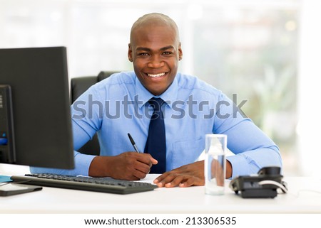 happy african corporate worker working in office
