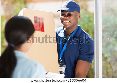 friendly young african american delivery man delivering a package