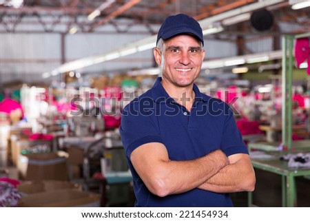 portrait of happy senior clothing factory owner