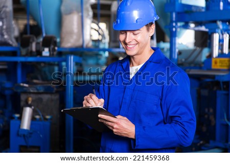 happy factory worker writing report