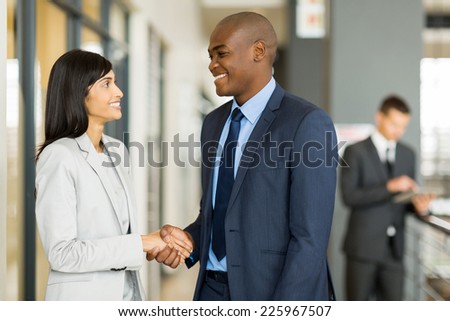 professional indian businesswoman handshaking with african businessman