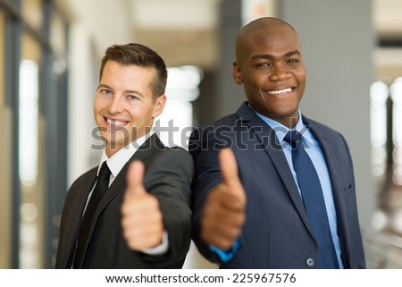 portrait of handsome multiracial business men thumbs up