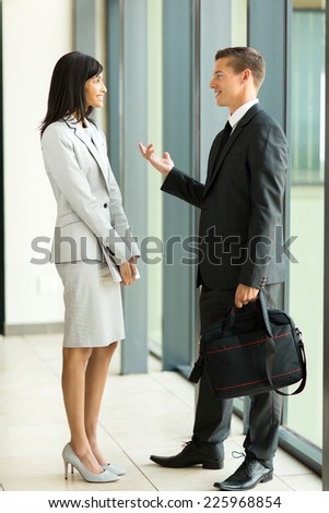 two colleagues having conversation in office