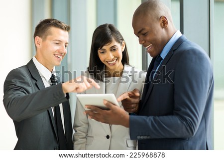 friendly business team using tablet computer in office