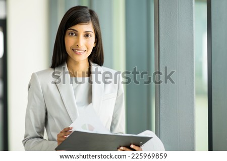 attractive indian business woman with financial report