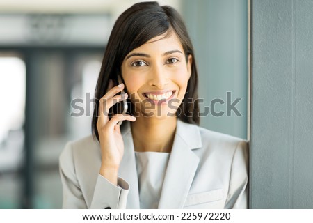 happy indian business woman talking on cell phone
