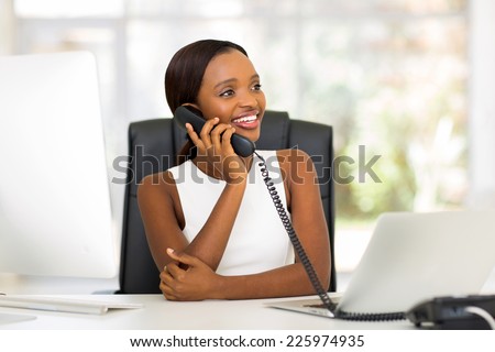 attractive african american businesswoman using landline phone