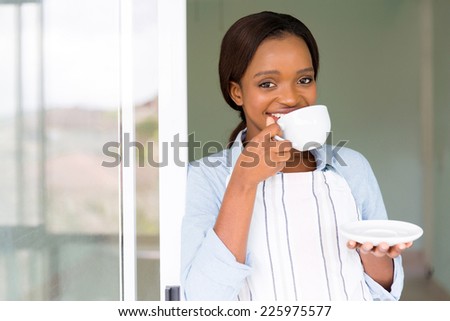 happy afro american woman having coffee at home